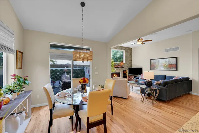 a living room with furniture a window and a wooden floor