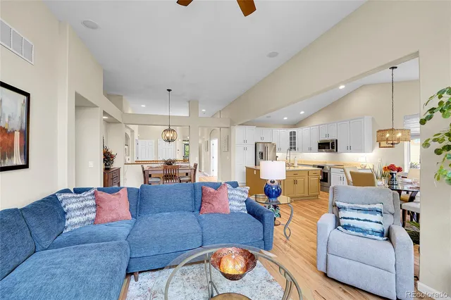 a living room with furniture and kitchen view