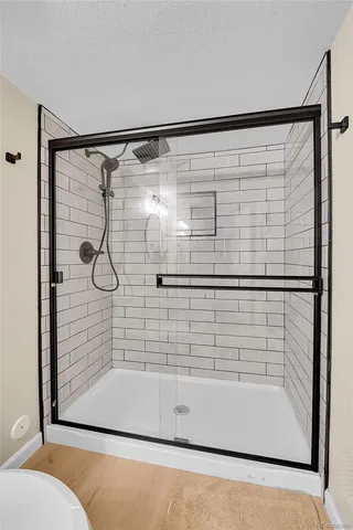 a roof deck with couches and potted plants