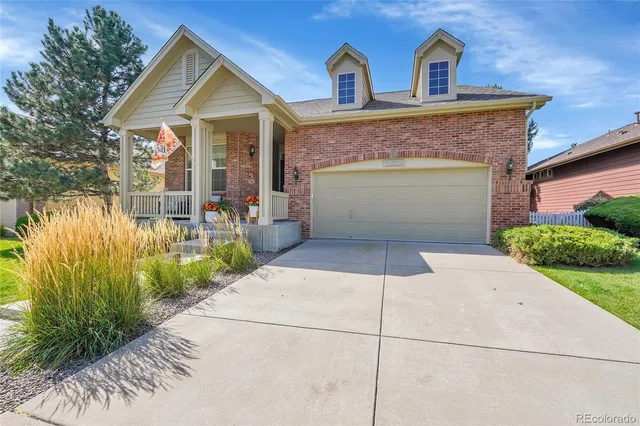 a aerial view of a house with a yard and potted plants