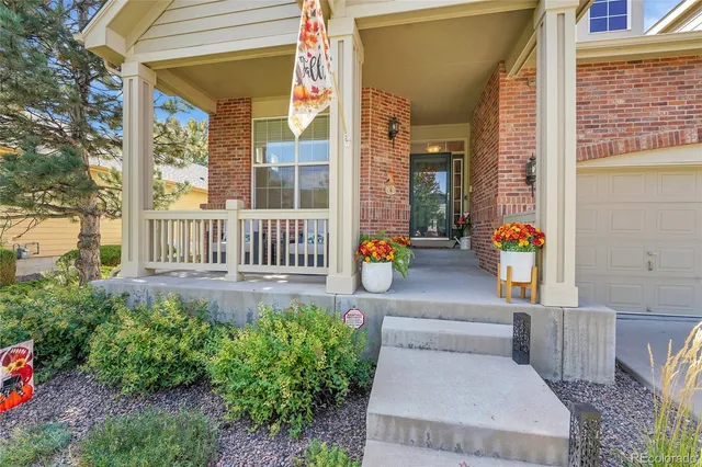 a aerial view of a house with a yard and fence