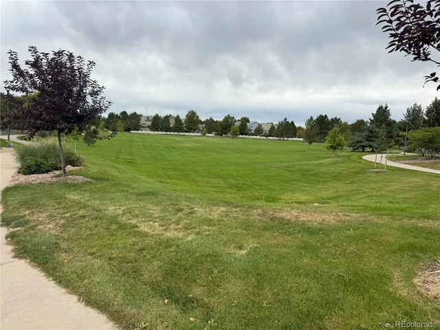 a view of a house with a yard and sitting area