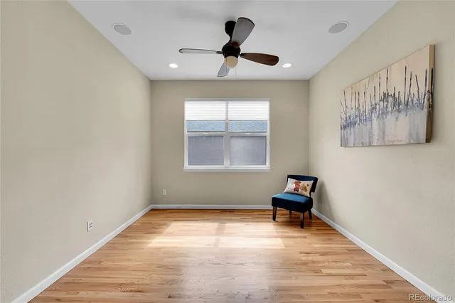 a room with a window and a ceiling fan