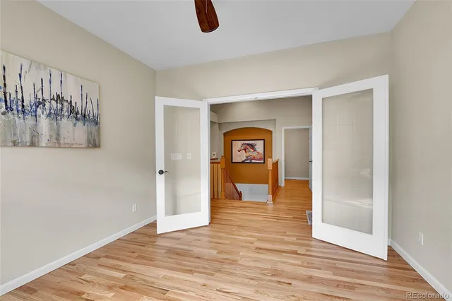 a view of empty room with wooden floor