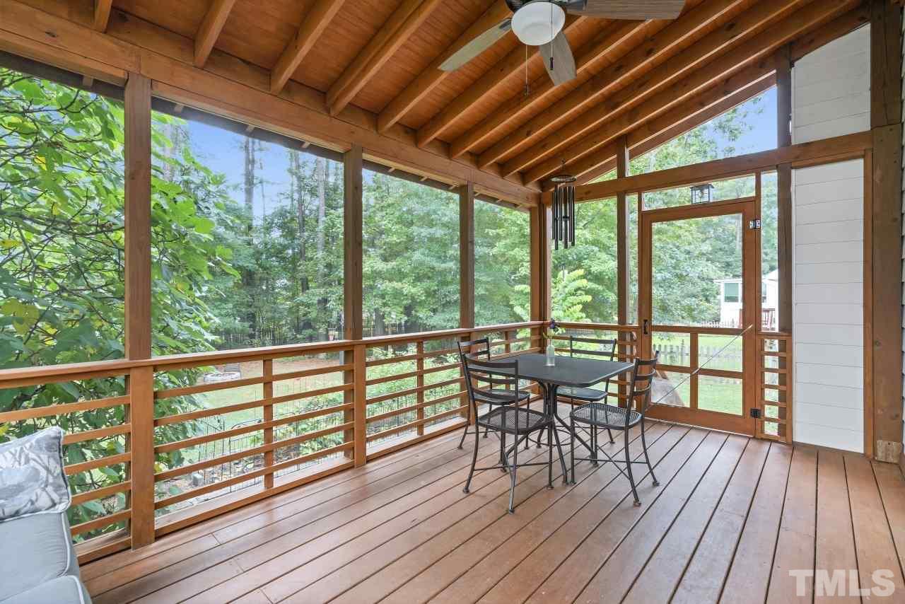 710 Windcrest Road Durham, NC 27713 - Photo 13 of 30 a view of a patio with table and chairs and wooden floor