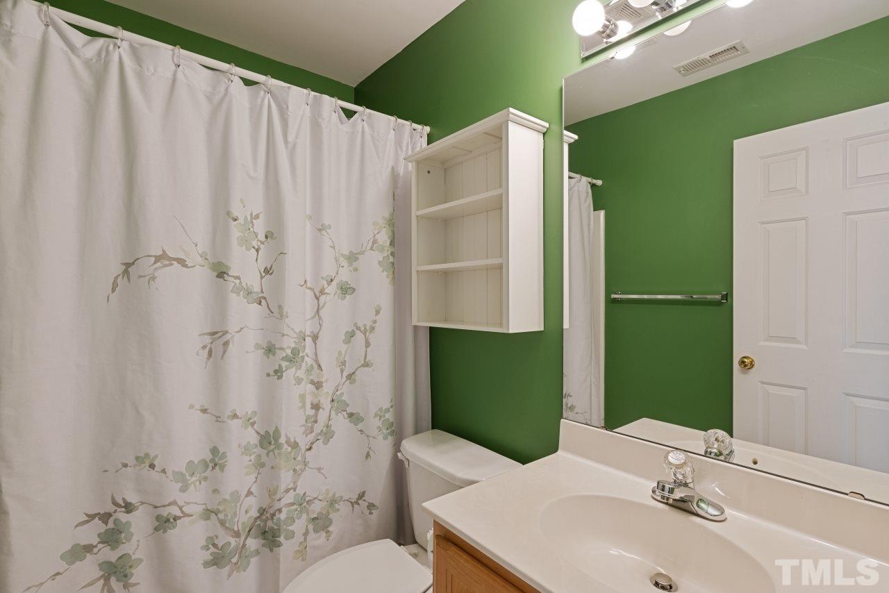 710 Windcrest Road Durham, NC 27713 - Photo 22 of 30 a bathroom with a sink a toilet and shower