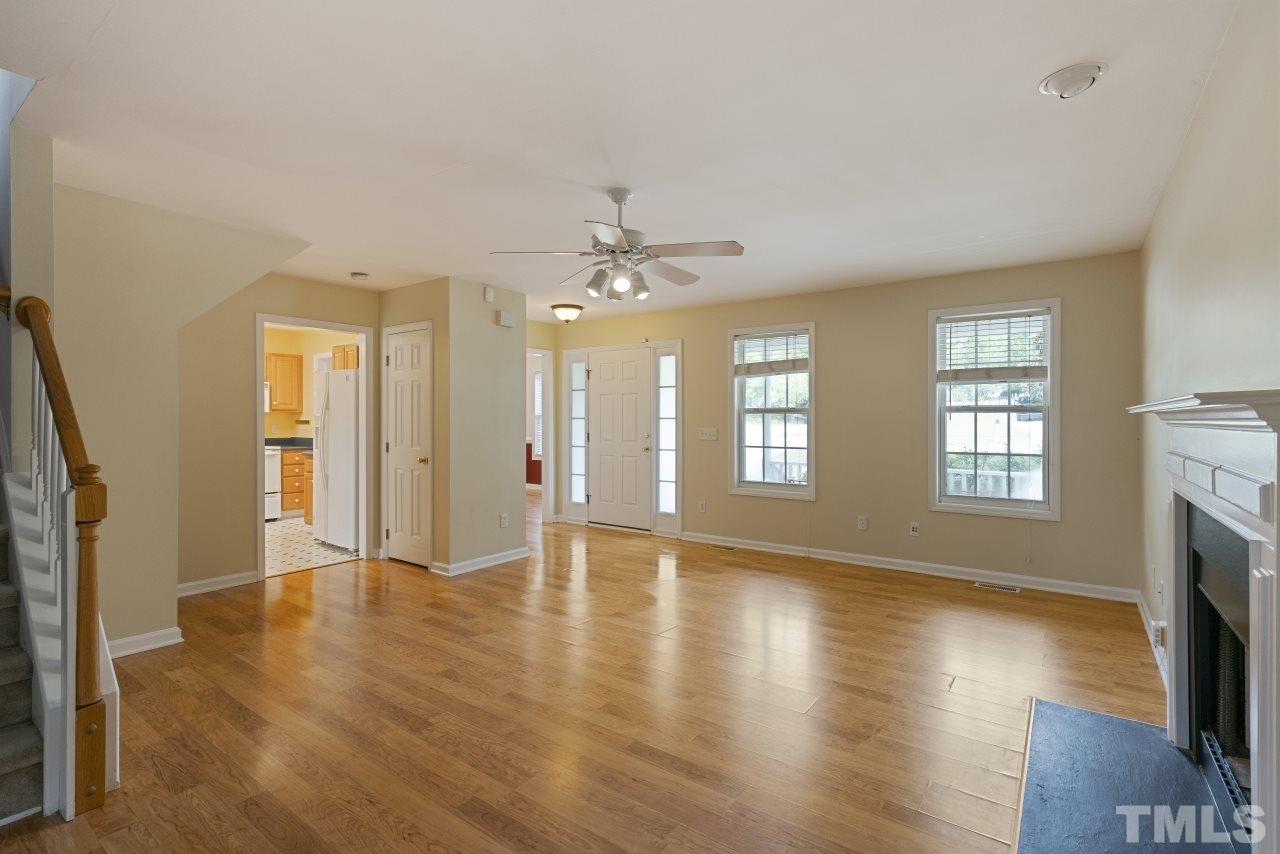 710 Windcrest Road Durham, NC 27713 - Photo 4 of 30 a view of an empty room with a fireplace and a window
