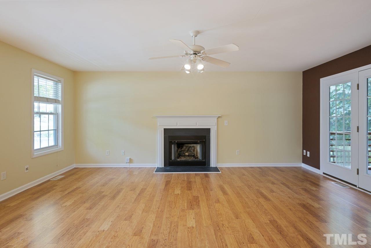 710 Windcrest Road Durham, NC 27713 - Photo 6 of 30 an empty room with windows and fireplace