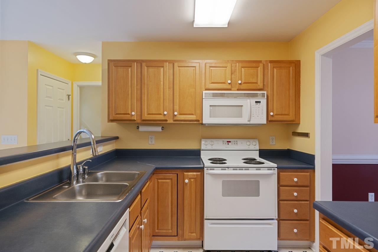 710 Windcrest Road Durham, NC 27713 - Photo 9 of 30 a kitchen that has a sink and a stove