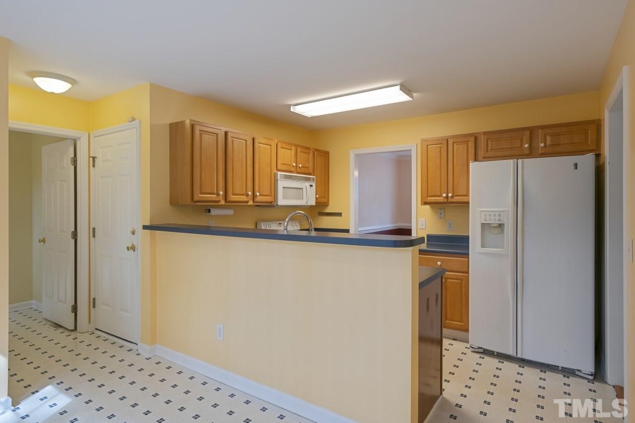 710 Windcrest Road Durham, NC 27713 - Photo 10 of 30 a kitchen with stainless steel appliances a refrigerator and a sink