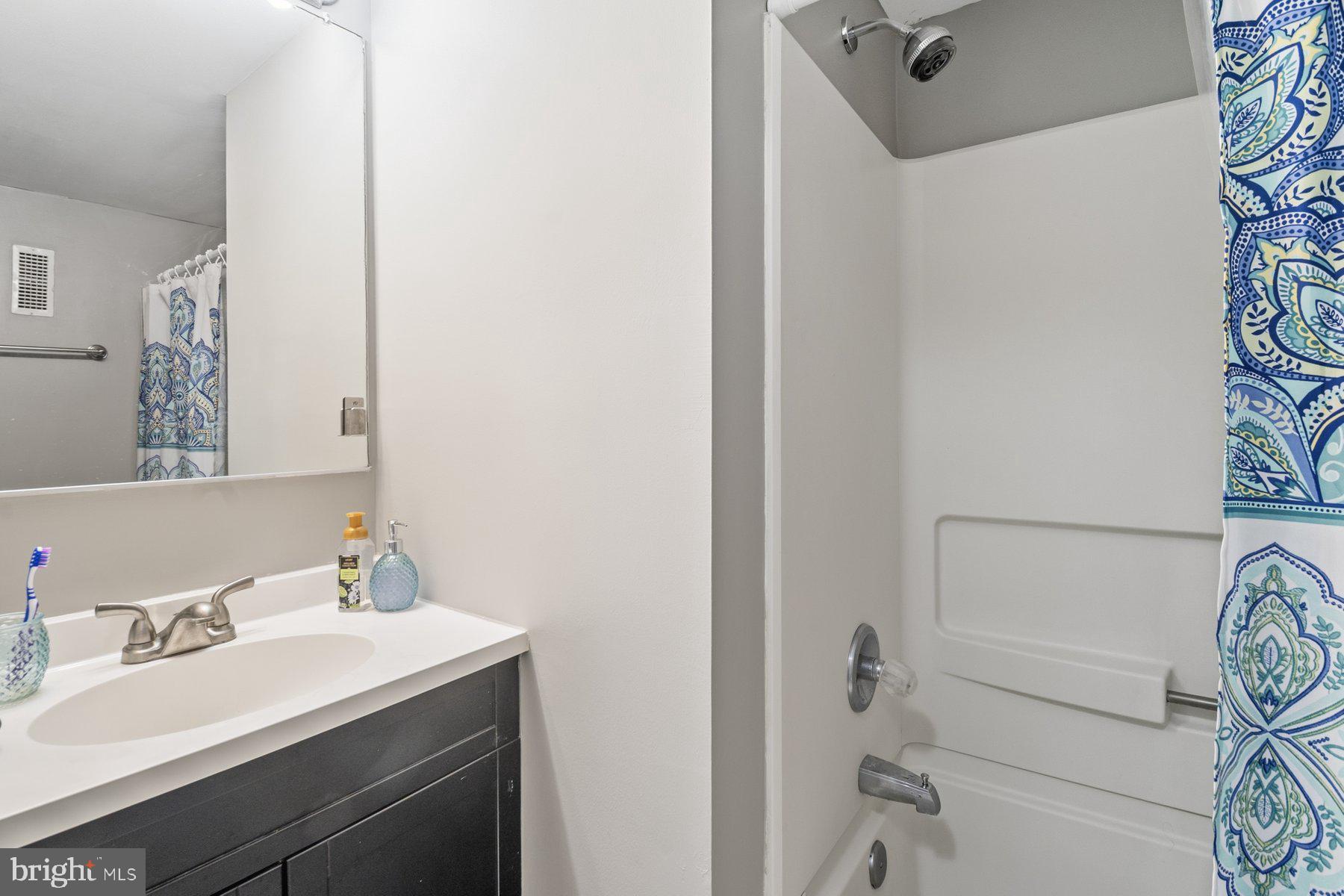 642 South Charles Street, Unit R 22 Baltimore, MD 21230 - Photo 22 of 26 a bathroom with a sink and a mirror