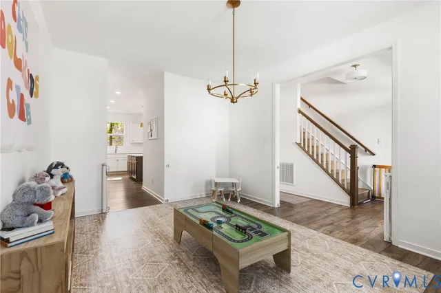 a living room with furniture and a dining table