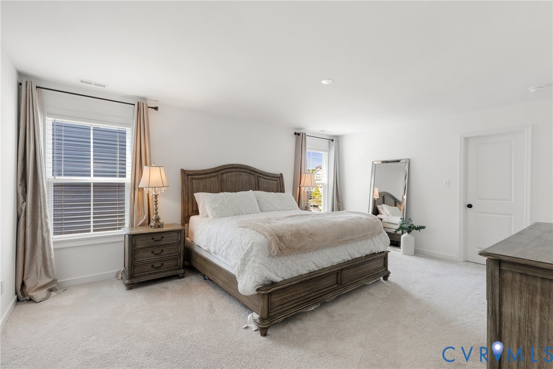 10001 Craftsbury Drive Midlothian, VA 23112 - Photo 19 of 32 a bedroom with a bed and a cabinets