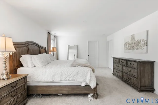 a bedroom with a bed and cabinet