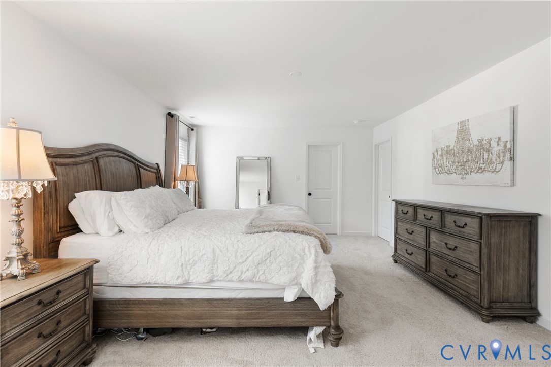 10001 Craftsbury Drive Midlothian, VA 23112 - Photo 21 of 32 a bedroom with a bed and cabinet