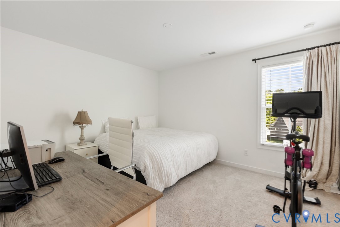 10001 Craftsbury Drive Midlothian, VA 23112 - Photo 26 of 32 a bedroom with a bed tv and a window