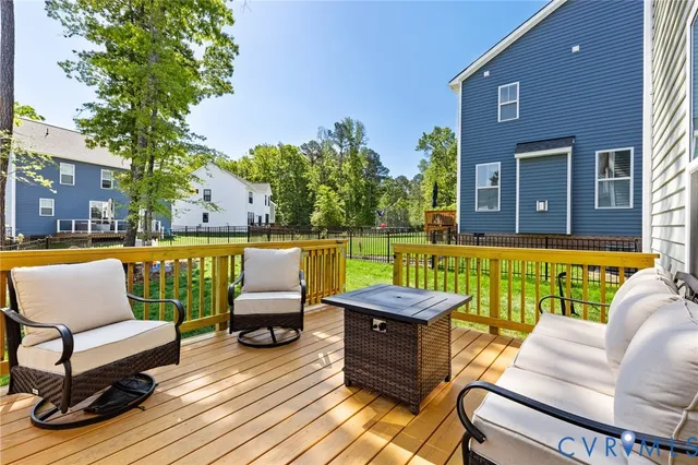 a view of a swimming pool with couches and lounge chairs