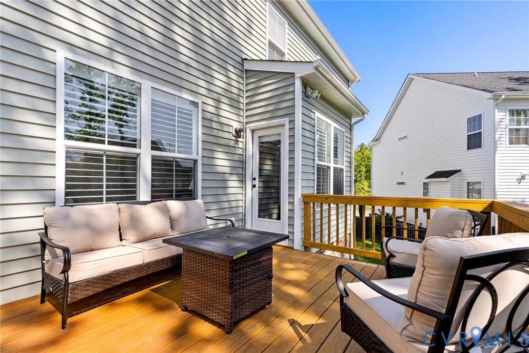 10001 Craftsbury Drive Midlothian, VA 23112 - Photo 30 of 32 a view of a patio with couches chairs and wooden floor