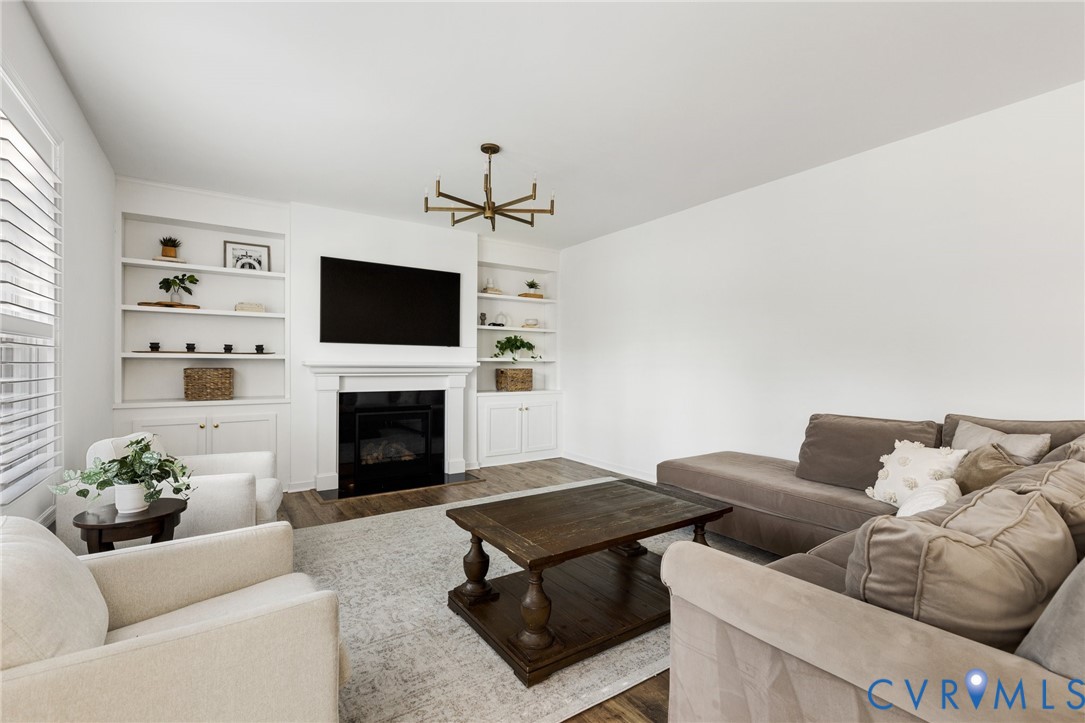 10001 Craftsbury Drive Midlothian, VA 23112 - Photo 6 of 32 a living room with furniture and a fireplace