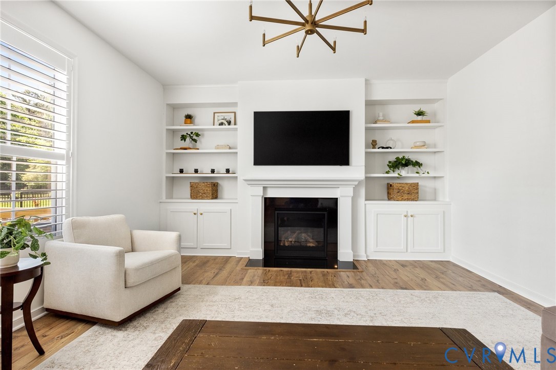 10001 Craftsbury Drive Midlothian, VA 23112 - Photo 7 of 32 a living room with furniture a flat screen tv and a fireplace