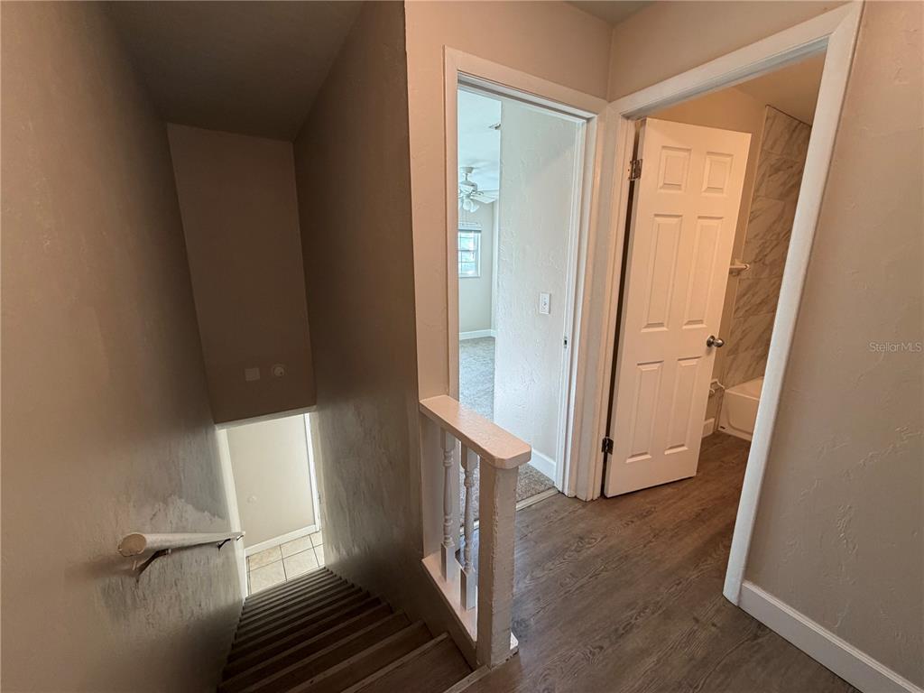 1718 Southwest 69th Terrace, Unit C Gainesville, FL 32607 - Photo 14 of 14 a view of a hallway with wooden floor and entryway