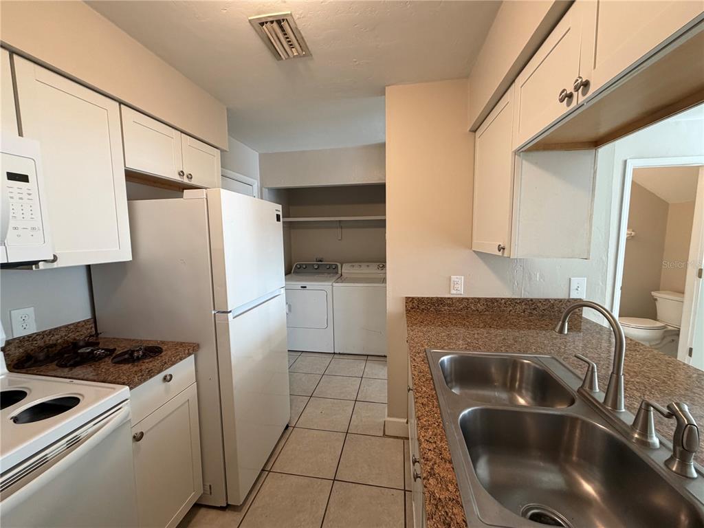 1718 Southwest 69th Terrace, Unit C Gainesville, FL 32607 - Photo 10 of 14 a kitchen with a refrigerator sink and stove