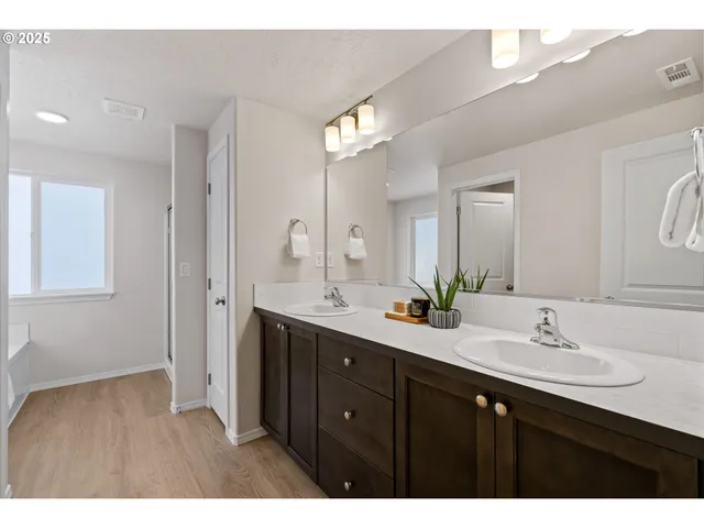 a bathroom with a double vanity sink and a mirror