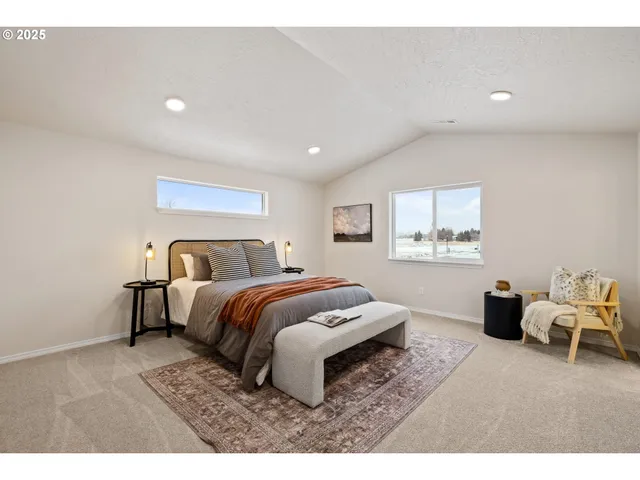 a bedroom with a bed and a chair