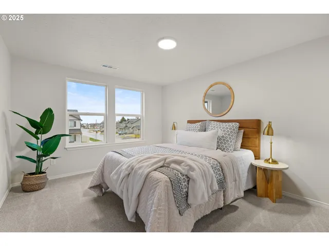 a bedroom with a bed and a potted plant