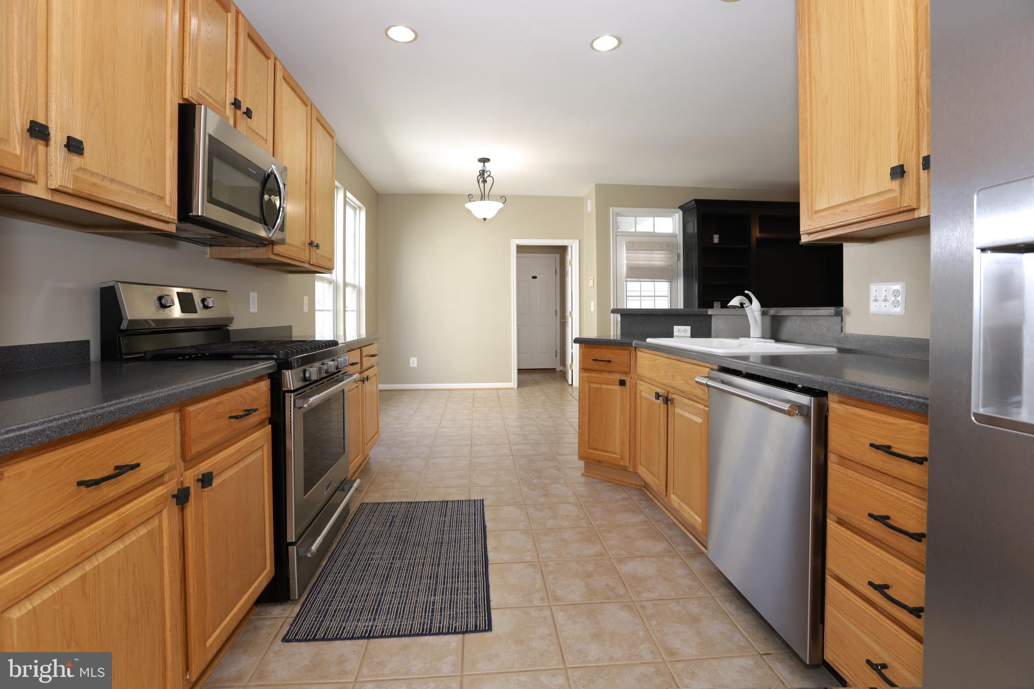 14205 Reidhall Place Gainesville, VA 20155 - Photo 11 of 54 Kitchen - all Stainless Appliances! View from DR