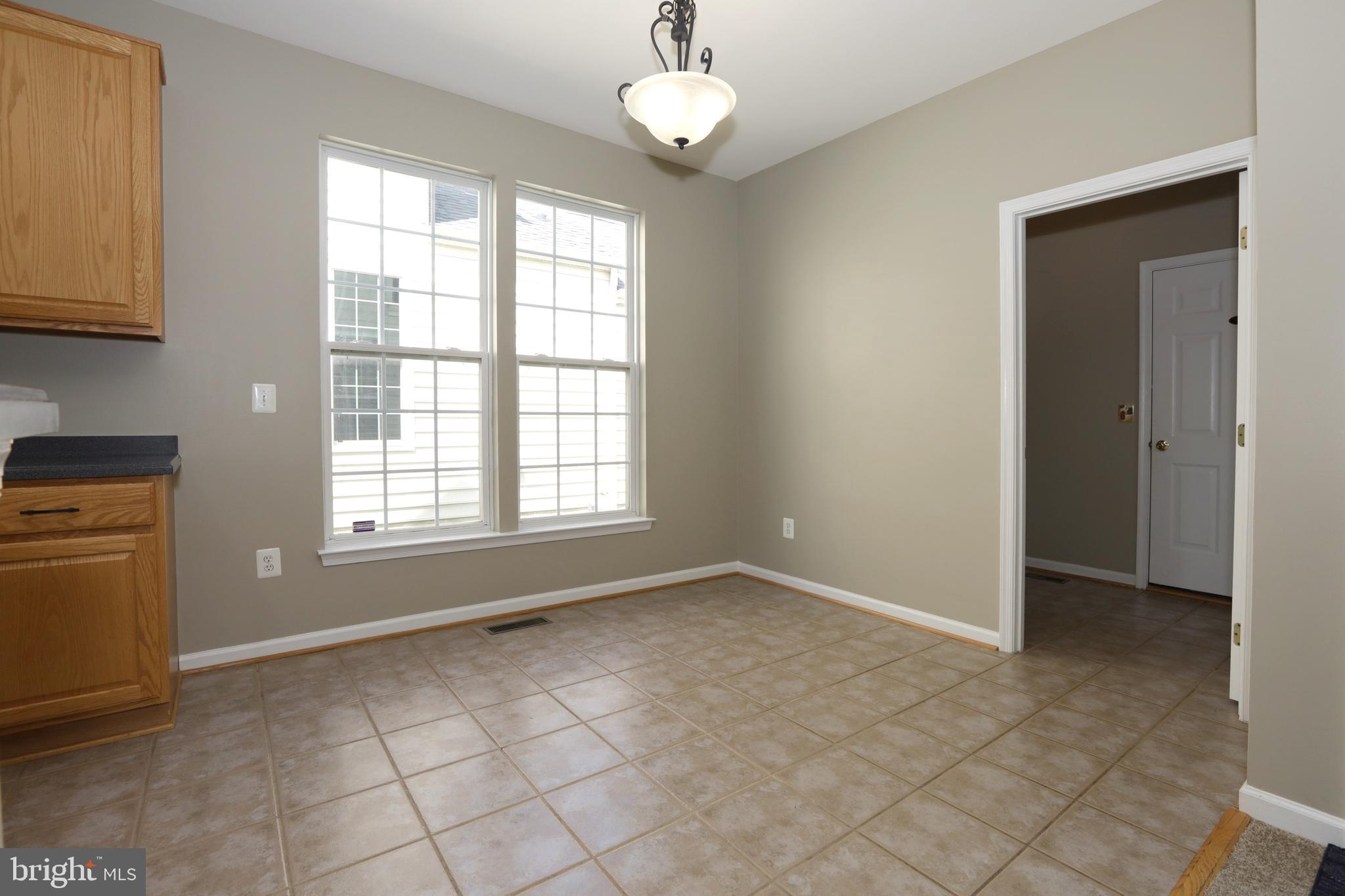 14205 Reidhall Place Gainesville, VA 20155 - Photo 15 of 54 Kitchen eat in are and door to Laundry and Garage