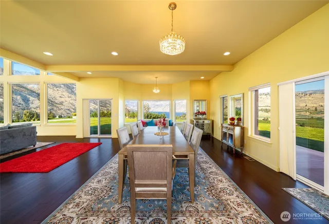 a living room with furniture and a floor to ceiling window