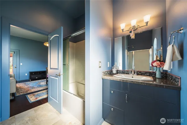 a bathroom with a double vanity sink and a mirror
