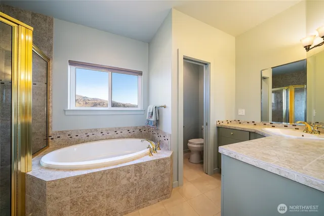 a bathroom with a tub sink and mirror