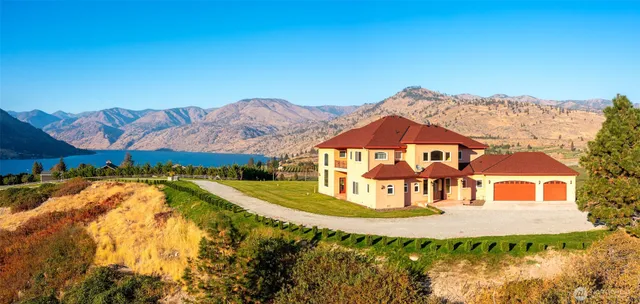 a view of a house with a garden and swimming pool