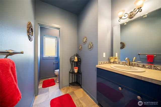 a bathroom with a sink vanity and a mirror