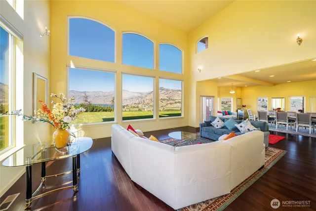 a living room with dining table and a large window