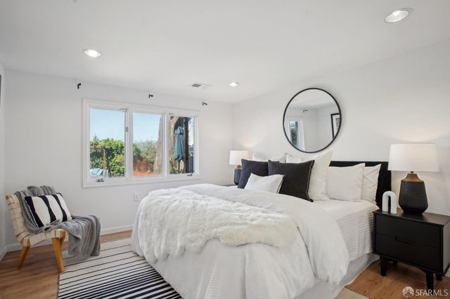 a bedroom with bed and a large window