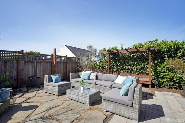 a outdoor living space with furniture and a potted plant