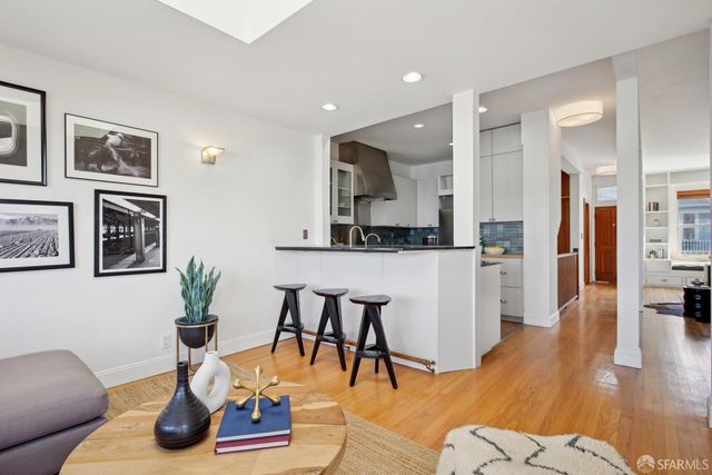 a living room with furniture and kitchen view