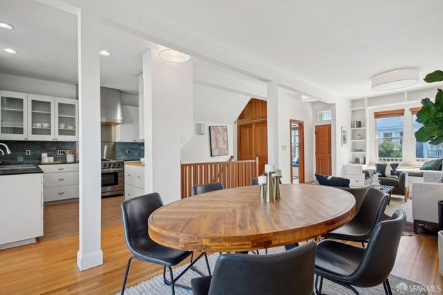 a dining room with furniture and wooden floor