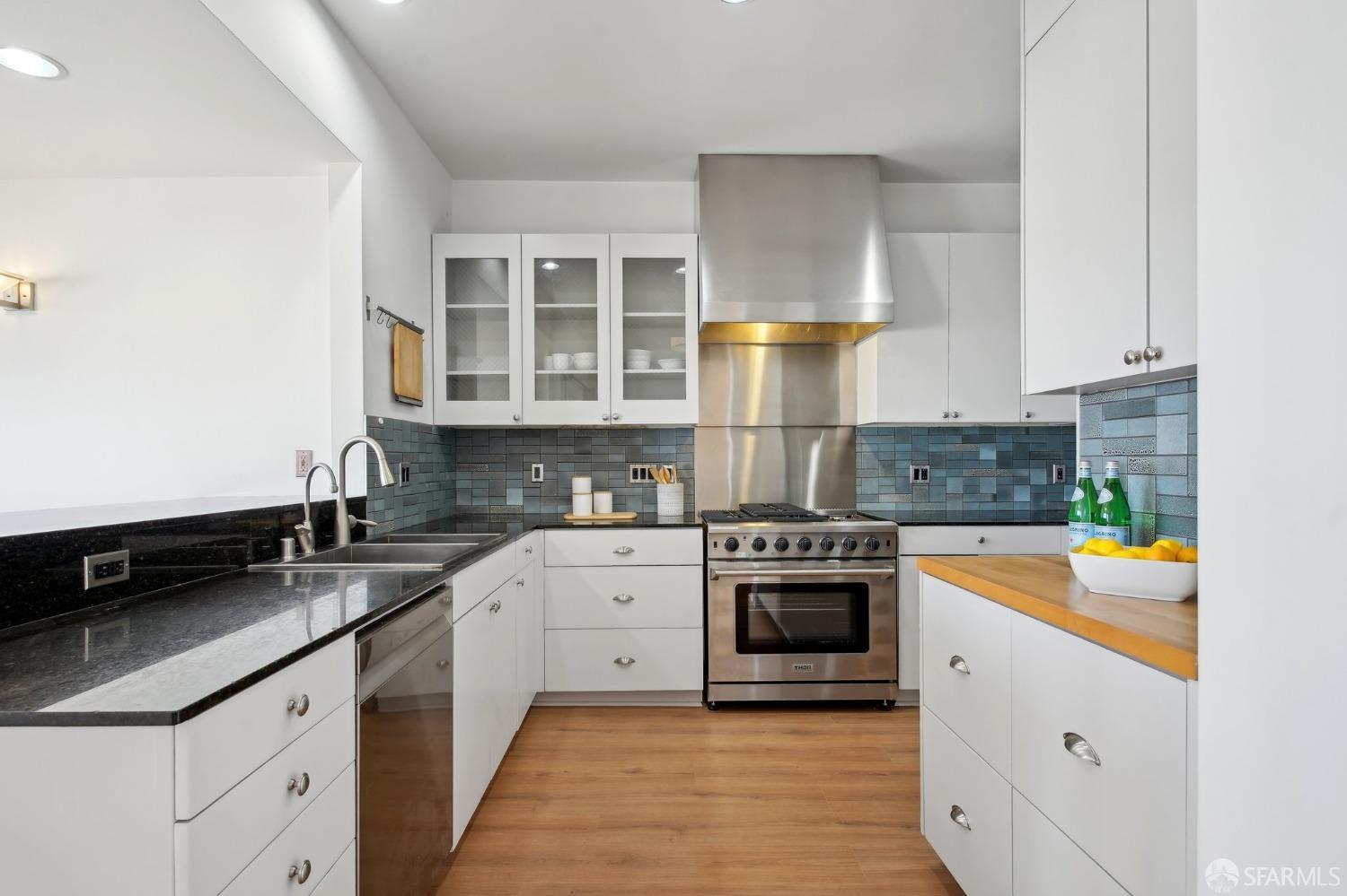 20 Wright Street San Francisco, CA 94110 - Photo 8 of 34 a kitchen with stainless steel appliances granite countertop a stove sink and cabinets
