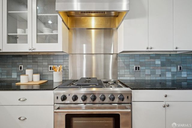 a kitchen with a stove and cabinets