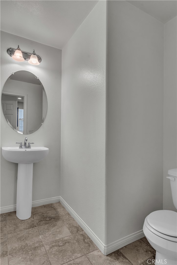 687 South Fillmore Avenue Rialto, CA 92376 - Photo 20 of 39 a bathroom with a sink toilet and a mirror