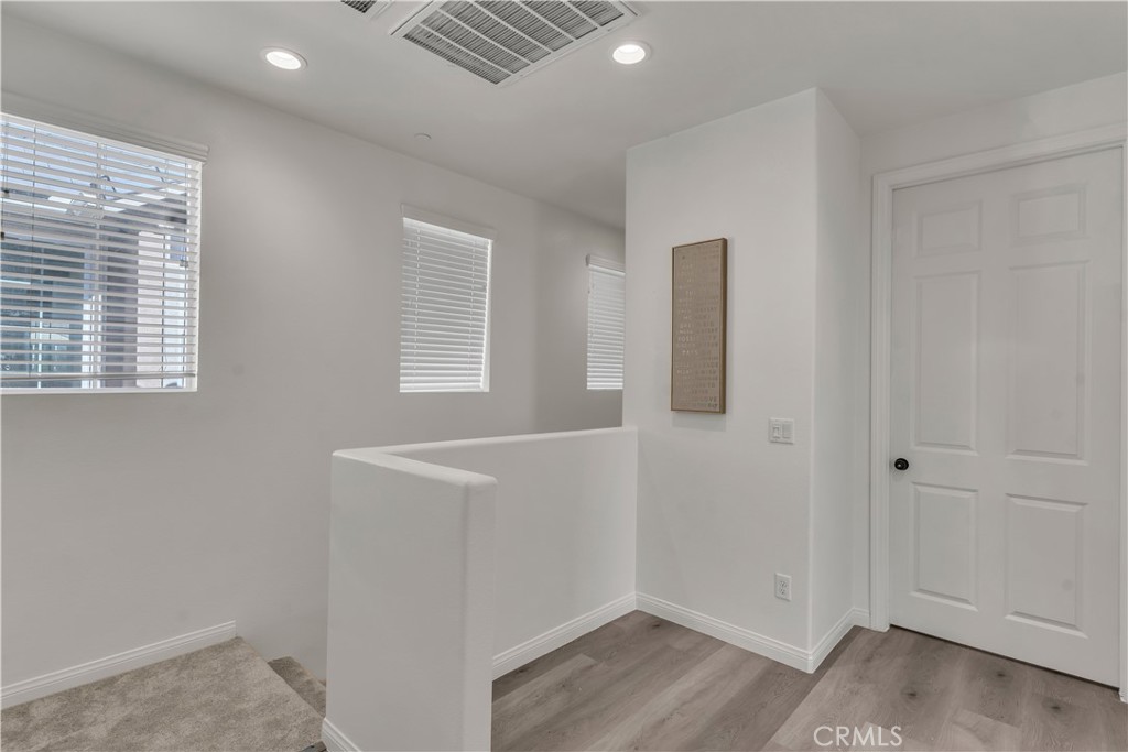 687 South Fillmore Avenue Rialto, CA 92376 - Photo 21 of 39 a view of an empty room with wooden floor and a window