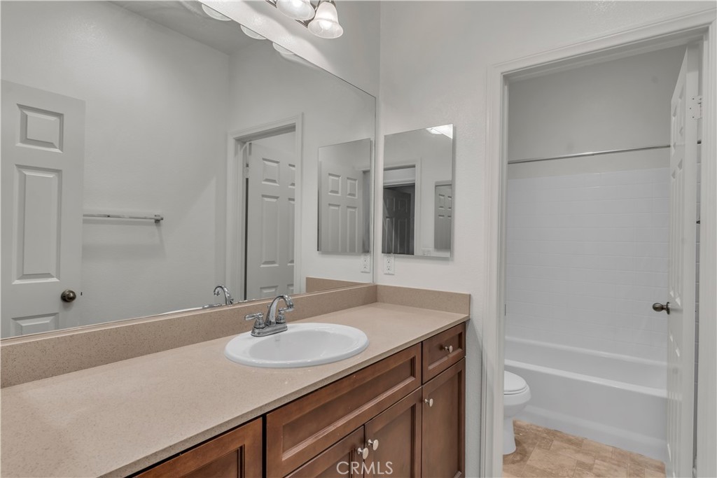 687 South Fillmore Avenue Rialto, CA 92376 - Photo 25 of 39 a bathroom with a sink and a mirror
