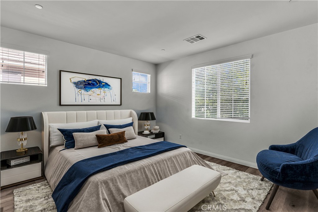 687 South Fillmore Avenue Rialto, CA 92376 - Photo 32 of 39 a bedroom with a bed and wooden floor