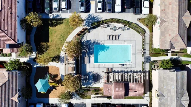 a view of swimming pool with a fountain and plants