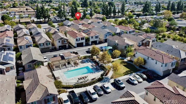 an aerial view of a house with yard swimming pool and ocean view