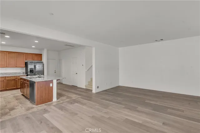 a view of kitchen with refrigerator stove microwave and stove